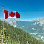 canada flag with mountain range view