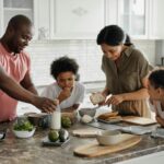 A joyful family enjoys preparing a healthy meal together in their modern kitchen.